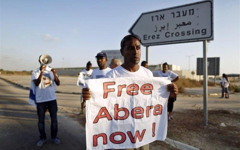 Israeli citizens of Ethiopian descent hold signs in 2015 appealing to Hamas for the release of Avera Mengistu, who was kidnapped after walking into Gaza a year earlier. File Photo by Abir Sultan/EPA-EFE