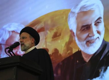 Iranian President Ebrahim Raisi addresses a ceremony marking anniversary of the death of the late Revolutionary Guard Gen. Qassem Soleimani, shown in the poster in background, who was killed in Iraq in a U.S. drone attack in 2020, at Imam Khomeini Grand Mosque in Tehran, Iran, Tuesday, Jan. 3, 2023. AP