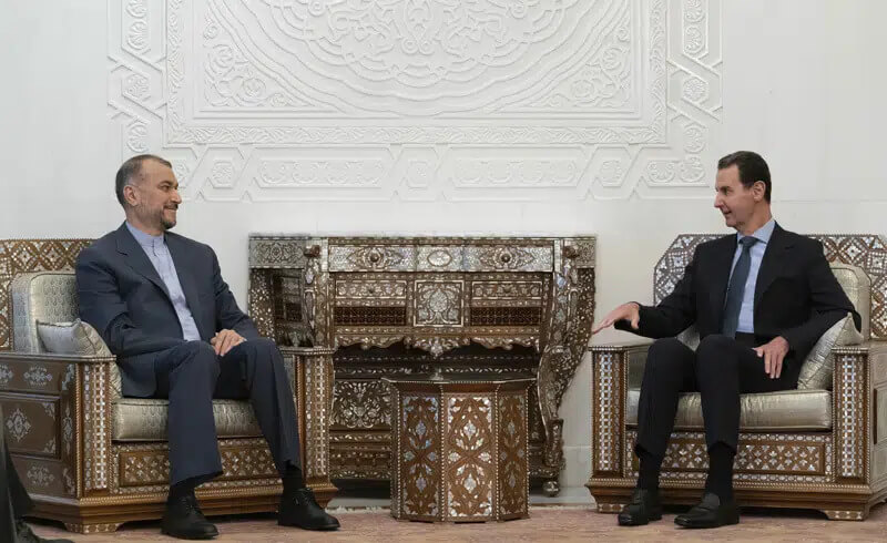 In this photo released on the official Facebook page of the Syrian Presidency, Syrian President Bashar Assad, right, meets with Iranian Foreign Minister Hossein Amirabdollahian in Damascus, Syria, Saturday, Jan. 14, 2023. (Syrian Presidency Facebook page via AP)