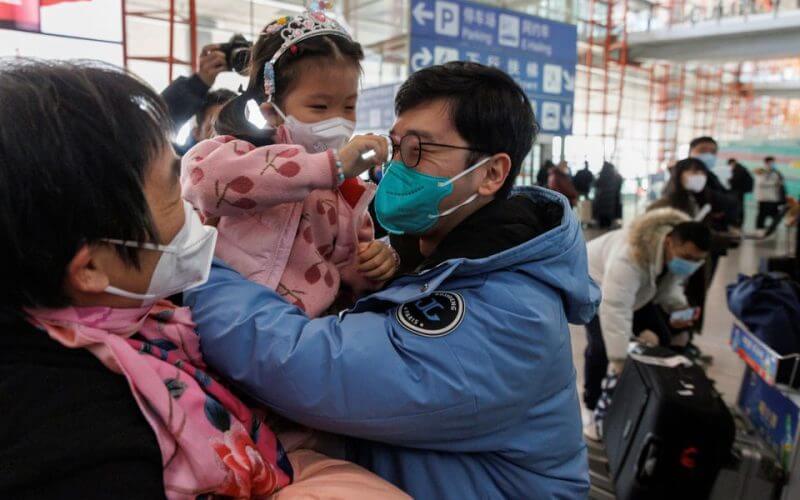 People embrace at the international arrivals gate at Beijing Capital International Airport after China lifted the coronavirus disease (COVID-19) quarantine requirement for inbound travellers in Beijing, China January 8, 2023. REUTERS