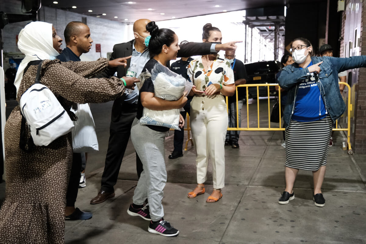Migrants bussed from Texas by Gov. Greg Abbott arrive at Port Authority in New York on Aug. 25. “This is a crisis that’s unfolding and it could undermine our cities in a real way,” New York Mayor Eric Adams said. | Spencer Platt/Getty Images