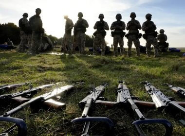 Weapons lie on the ground as Ukrainian personnel take a break during training at a military base with UK Armed Forces in Southern England on Oct. 12, 2022. AP