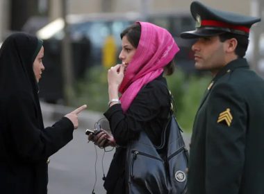 An Iranian policewoman (L) warns a woman about her clothing and hair during a crackdown to enforce Islamic dress code in Tehran, Iran (Getty Images)