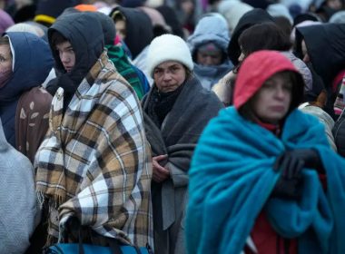 Refugees wait in a crowd for transportation after fleeing from Ukraine and arriving at the border crossing in Medyka, Poland, on March 7, 2022. AP