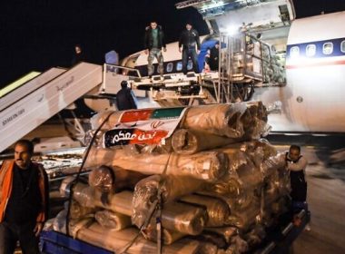 Workers unload aid from a plane sent by Iran, at the airport in Syria's northern city of Aleppo, early on February 8, 2023, following a deadly earthquake. (AFP)