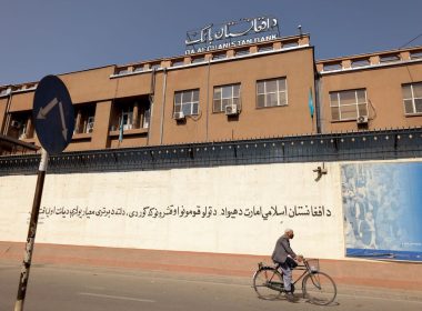 A man rides a bike in front of the Bank of Afghanistan in Kabul, Afghanistan October 8, 2021. REUTERS/Jorge Silva/File Photo