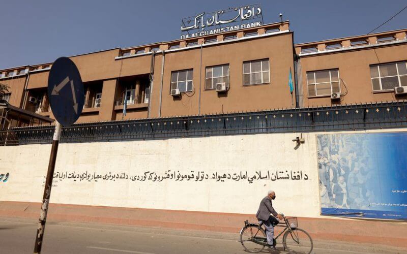 A man rides a bike in front of the Bank of Afghanistan in Kabul, Afghanistan October 8, 2021. REUTERS/Jorge Silva/File Photo