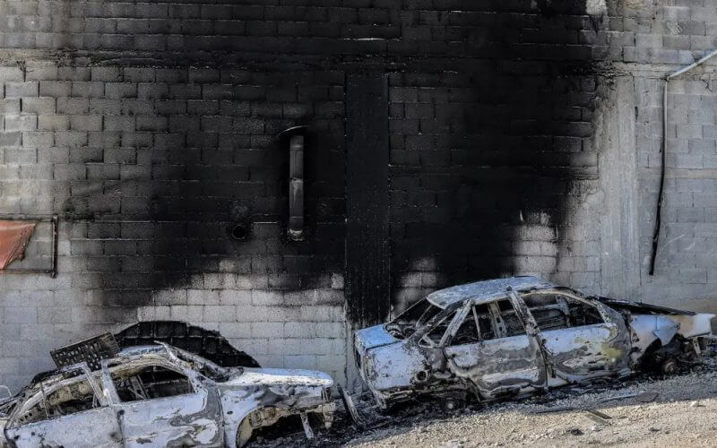 A view of torched cars and a building in the town of Huwara near Nablus in the West Bank. AFP