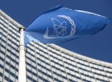 A flag with the logo of the International Atomic Energy Agency (IAEA) waves in front of the IAEA headquarters, amid the coronavirus disease (COVID-19) outbreak in Vienna, Austria, March 1, 2021. REUTERS/Lisi Niesner