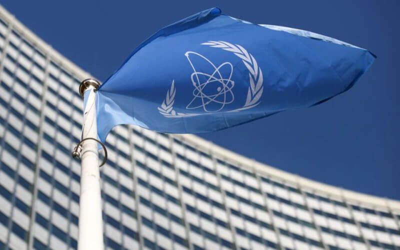 A flag with the logo of the International Atomic Energy Agency (IAEA) waves in front of the IAEA headquarters, amid the coronavirus disease (COVID-19) outbreak in Vienna, Austria, March 1, 2021. REUTERS/Lisi Niesner