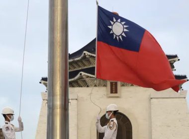 Two soldiers lower the national flag during the daily flag ceremony on Liberty Square of the Chiang Kai-shek Memorial Hall in Taipei, Taiwan, July 30, 2022.