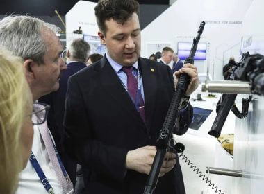 A salesman shows off an AK-19 Kalashnikov rifle at a tent for Russian weapons manufacturers at the International Defense Exhibition and Conference in Abu Dhabi, United Arab Emirates, Monday, Feb. 20, 2023. AP