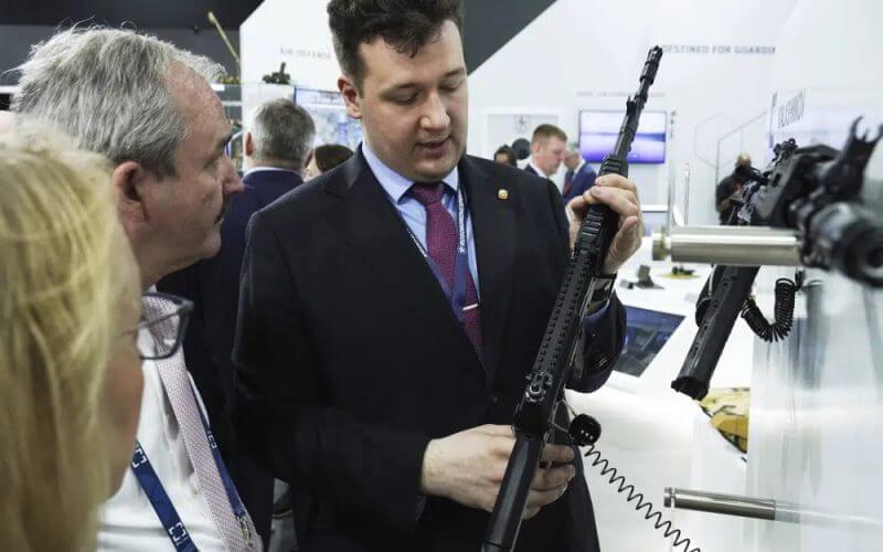 A salesman shows off an AK-19 Kalashnikov rifle at a tent for Russian weapons manufacturers at the International Defense Exhibition and Conference in Abu Dhabi, United Arab Emirates, Monday, Feb. 20, 2023. AP