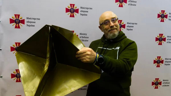Ukraine's Defense Minister, Oleksii Reznikov, poses with a reflector similar to the one the air force says it shot down from the balloons. Ukraine Defense Ministry