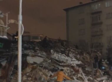 People look through rubble of a collapsed building in Trueky following an earthquake on February 6, 2023. (screen capture: Twitter)