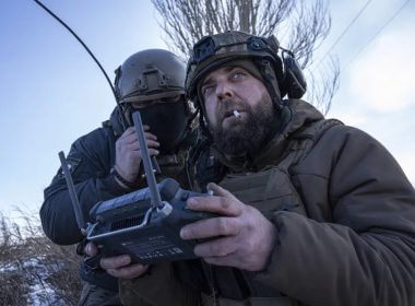 A Ukrainian serviceman aka Zakhar, right and commander of a unit aka Kurt, look on a screen of a drone remote control during fighting, at the frontline in Donetsk region, Ukraine, Monday, Feb. 13, 2023. (AP Photo/Evgeniy Maloletka)