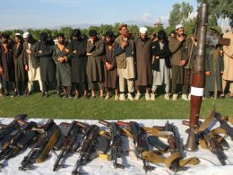 Members of ISIS-K stand in front of their weapons as they surrendered to the government in Jalalabad, Nangarhar, Afghanistan on November 17, 2019. Wali Sabawoon/Getty Images