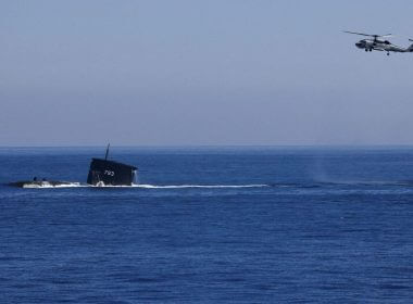 A S70C helicopter can be seen flying around SS793 submarine as part of Taiwan's main annual "Han Kuang" exercises, as 20 naval vessels including frigates and destroyers fired shells to simulate intercepting and attacking an invading force, off Taiwan's northeastern coast, in Yilan, Taiwan, July 26, 2022. REUTERS