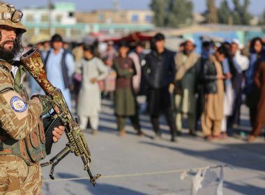 A Taliban security member stands guard along the Pakistan border in Nangarhar province, on Feb. 23. A new report said the Taliban are using fingerprint and gun records to track down those who helped the U.S. (Shafiullah Kakar/AFP via Getty Images)