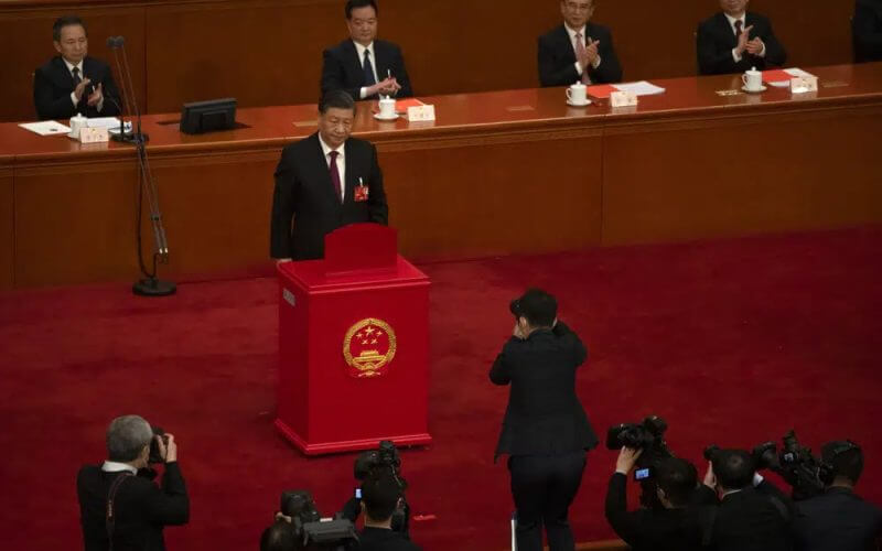 Chinese President Xi Jinping casts his vote during a session of China's National People's Congress (NPC) at the Great Hall of the People in Beijing, Friday, March 10, 2023. AP