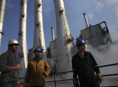 Iranian oil workers gather at an oil refinery south of the capital Tehran, Dec. 22, 2014. AP