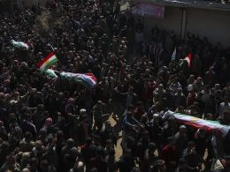 People attend funeral of four four Kurds in the town of Jinderis, Syria, Tuesday, March 21, 2023. AP