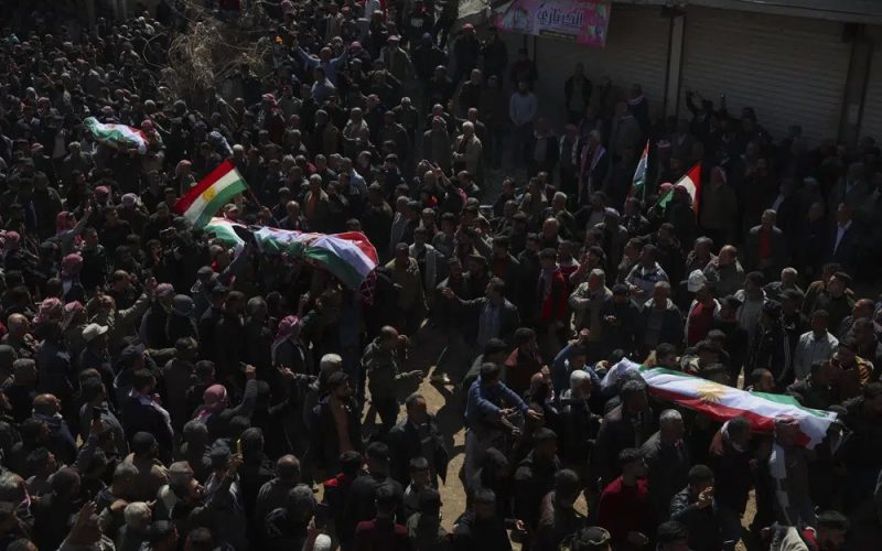 People attend funeral of four four Kurds in the town of Jinderis, Syria, Tuesday, March 21, 2023. AP