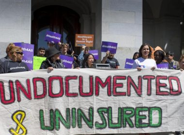 Advocates for a bill to provide health care to undocumented immigrants rally in at the Capitol in Sacramento. (Photo by LA Times/Hector Amezcua)