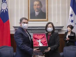 In this file photo released by the Taiwan Presidential Office, then outgoing Honduran President Juan Orlando Hernandez, left, exchanges gifts with Taiwanese President Tsai Ing-wen during a meeting in Taipei, Taiwan on Nov. 13, 2021. AP