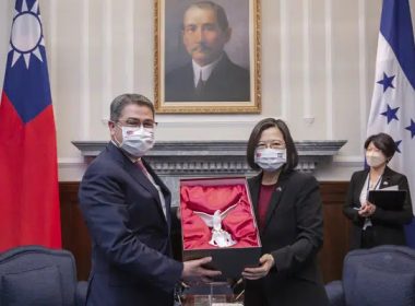 In this file photo released by the Taiwan Presidential Office, then outgoing Honduran President Juan Orlando Hernandez, left, exchanges gifts with Taiwanese President Tsai Ing-wen during a meeting in Taipei, Taiwan on Nov. 13, 2021. AP