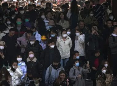 People, some wearing face masks visit the Temple of Heaven park in Beijing, Sunday, Feb. 26, 2023. Visitors flock to the tourist sites in cities in China after authorities lifted all bans on public gatherings from the outbreak of COVID-19. (AP Photo/Andy Wong)