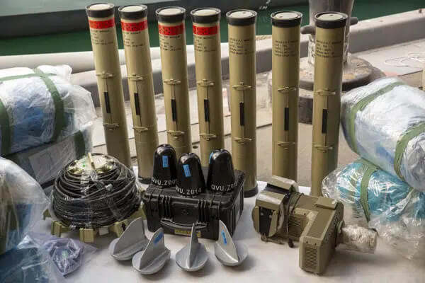 In this photo from the U.S. Army, anti-tank missiles and medium-range ballistic missile components seized by the United Kingdom Royal Navy sit pier side at an undisclosed location in the Middle East on Feb. 26, 2023. AP