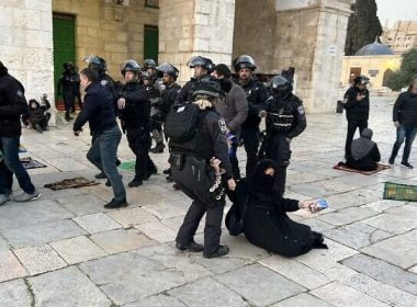 Israeli security forces remove Palestinian Muslim worshipers sitting on the grounds of the Al-Aqsa Mosque compound in Jerusalem, early on April 5, 2023. (Ahmad Gharabli/AFP)