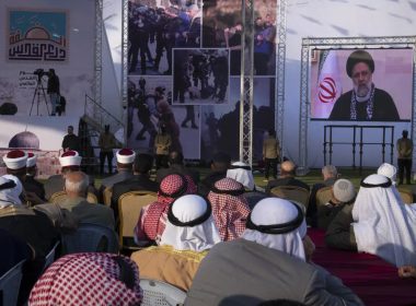 Palestinians watch a pre-recorded speech by Iranian President Ebrahim Raisi on "Jerusalem Day," which is called al-Quds Day after the city's Arabic name, at a soccer filed in Gaza City, Friday, April 14, 2023. AP