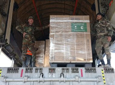 In this photo released by the official Syrian state news agency SANA, Syrian soldiers unload humanitarian aid sent from Saudi Arabia following a devastating earthquake, at the airport in Aleppo, Syria, Tuesday, Feb. 14, 2023. (SANA via AP)