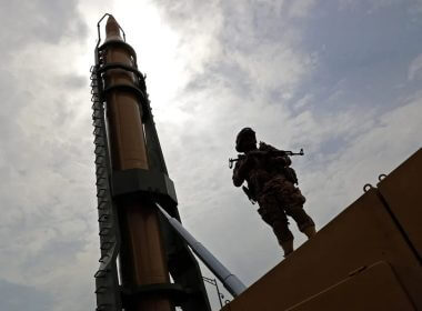 An Iranian soldier stands next to an Iranian Shahab-3 missile. Getty Images