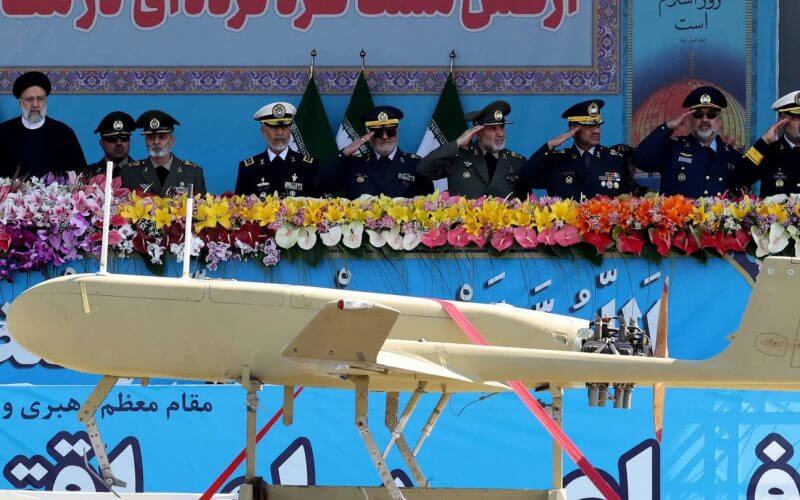 Iranian President Ebrahim Raisi, left, watches combat drones alongside high-ranking officials and commanders during a military parade marking the country's annual Army day in Tehran on April 18, 2023. (Atta Kenare/AFP via Getty Images)