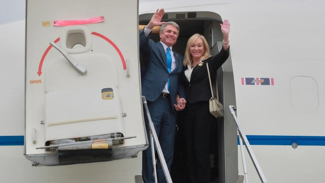 In this photo released by the Taiwan Presidential Office, Michael McCaul, chairman of the Foreign Affairs Committee in the United States House of Representatives and his wife Linda Mays McCaul wave from a charter plane as they arrive in Taipei, Taiwan, Thursday, April 6, 2023. (Taiwan Presidential Office via AP)