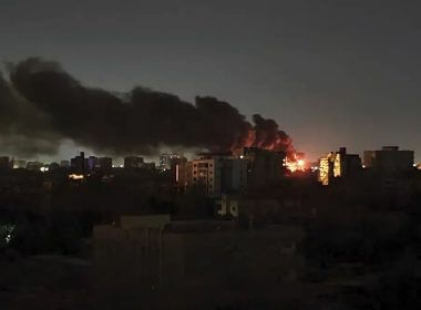 Smoke rises over the horizon as a fire burns after a strike in Khartoum, Sudan, Sunday, April 16, 2023. (AP Photo/Abdullah Moneim)