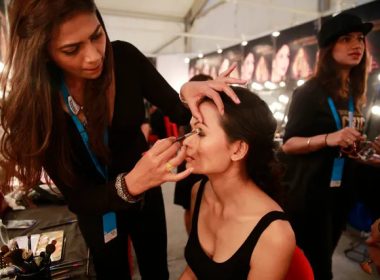 In this Feb. 1, 2017 photo, a makeup artist applies eye-shadow on Anjali Lama, a transgender model from Nepal, during Lakme Fashion week in Mumbai, India. AP