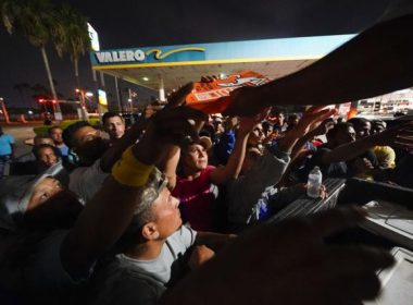 Migrants receives pizza from volunteers after being released from a respite center at the Texas-Mexico border, Thursday, May 11, 2023, in Brownsville, Texas. Julio Cortez | AP
