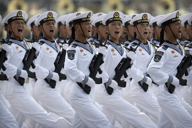 Soldiers from China's People's Liberation Army (PLA) Navy march in formation during a parade to commemorate the 70th anniversary of the founding of Communist China in Beijing, Oct. 1, 2019. (AP Photo/Mark Schiefelbein, File)