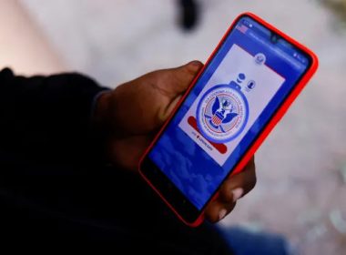 A migrant from Venezuela seeking asylum in the US uses his phone to access the CBP One application. Photograph: José Luis González/Reuters