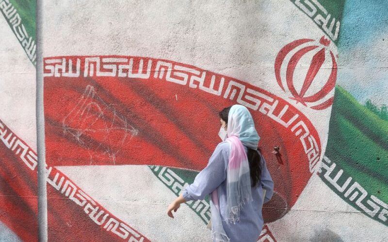An Iranian woman walks in a street in Tehran, Iran, April 9, 2023. Majid Asgaripour/WANA (West Asia News Agency) via REUTERS