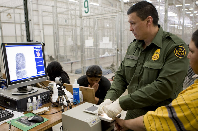 A Border Patrol agent processes individuals at a facility in Nogales, Arizona. (CBP)