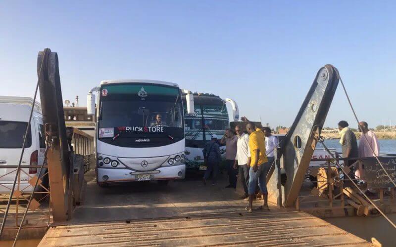 Buses carrying Sudanese, who fled the fighting in Sudan's capital, are leaving a ferry that transported to Egypt's southern city of Abu Simbel on Sunday, May 7, 2023. (AP Photo/ Samy Magdy)
