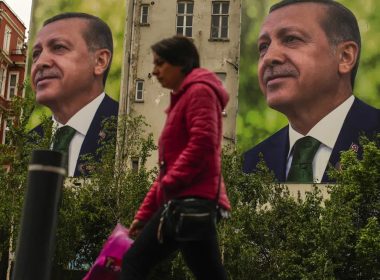 A person walks past billboards of Turkish President and People's Alliance's presidential candidate Recep Tayyip Erdogan a day after the presidential election day, in Istanbul, Turkey, Monday, May 15, 2023. (AP Photo/Emrah Gurel)