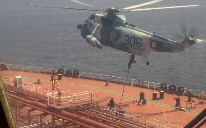 In this frame grab from video footage released Friday April 28, 2023 by the Iranian Navy, Iranian marines rappel onto the Advantage Sweet, a Marshall Islands-flagged oil tanker's deck in the Gulf of Oman. AP