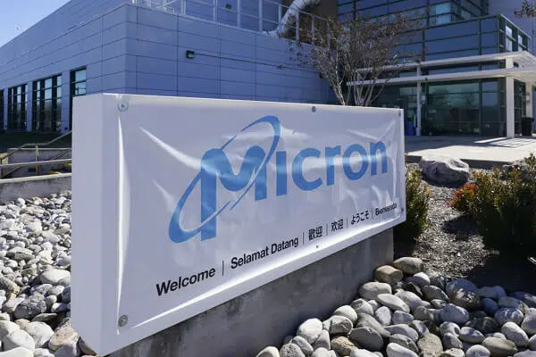 A sign marks the entrance of the Micron Technology automotive chip manufacturing plant on Feb. 11, 2022, in Manassas, Va. (AP Photo/Steve Helber, File)