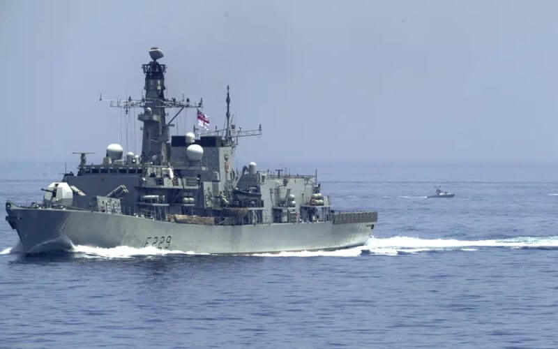 The British frigate HMS Lancaster sails as Iranian Revolutionary Guard vessels follow behind it in the Strait of Hormuz Friday, May 19, 2023. (AP Photo/Jon Gambrell)